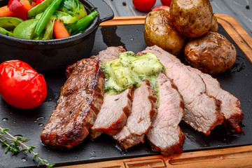 Juicy steak medium rare beef with spices and grilled vegetables