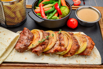Fresh, home-cooked on the grill fire meat beef shish kebab with vegetables and spices