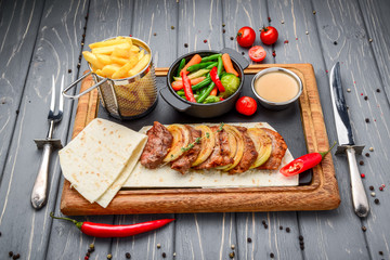 Fresh, home-cooked on the grill fire meat beef shish kebab with vegetables and spices