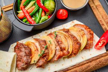 Fresh, home-cooked on the grill fire meat beef shish kebab with vegetables and spices