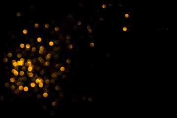 Golden abstract bokeh on black background. Holiday concept