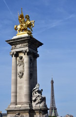 Tour Eiffel from Pont Alexandre III with blue sky. Paris, France.