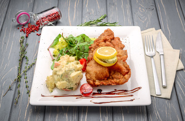 Wiener Schnitzel with potato salad and lemon
