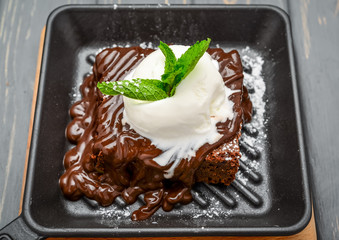 A slice of chocolate cake and vanilla ice cream