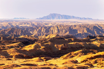 Sunrise lights the Yellow Moon valley.  Desert Landscape in Africa. Namibia