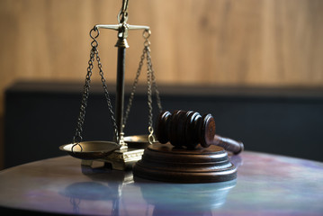 Law and Justice concept. Mallet of the judge, books, scales of justice. Gray stone background,...