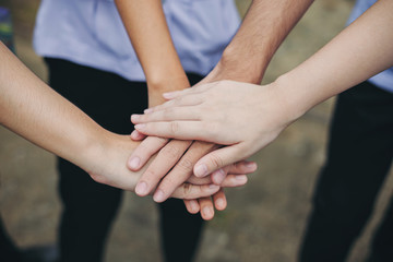 Group of students or businessman hands together joining for teamwork, community,  togetherness and business collaboration concept.