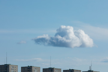 Fototapeta premium A large cloud is hanging above some buildings