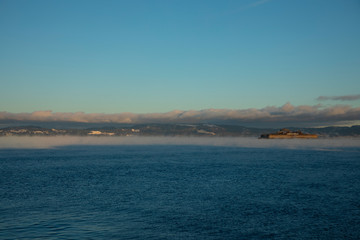 A cloudy blue cold day by the water by the mist