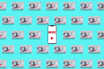 Background with old cassette tapes and smartphone
