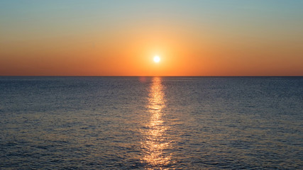 View of the calm sea and sunset sky