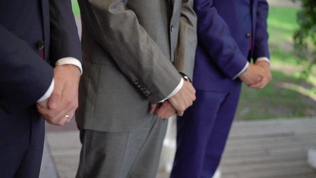 Groomsmen friends staying at wedding ceremony.
