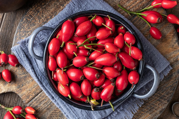 Rose hips in a blue pot, top view