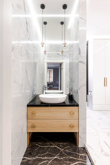 Stylish modern luxurious marble bathroom with original fixtures and a washbasin