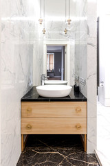 Stylish modern luxurious marble bathroom with original fixtures and a washbasin