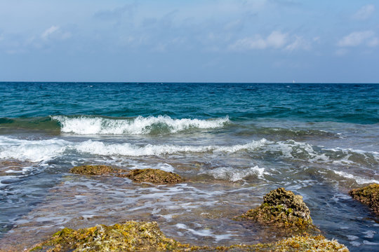 Mediterranean Sea waves over brow low rocks