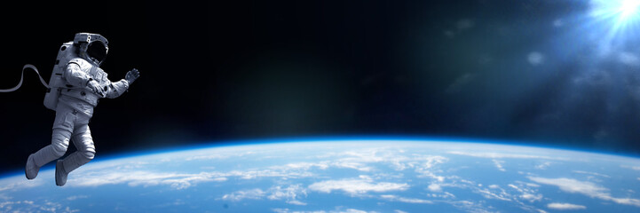 astronaut in EVA spacesuit performing a spacewalk