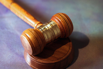 Law and Justice concept. Mallet of the judge, books, scales of justice. Gray stone background,...