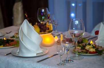 Beautiful festive table setting. Delicious snack on their plates