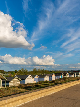 Clouds over the Beach Huts at the North Beach in Heacham, Norfolk, England, UK