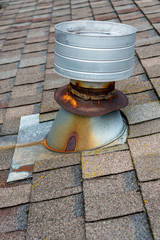 Residential home asphalt shingle rooftop with round roof vent