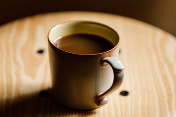 cup of coffee on wooden table