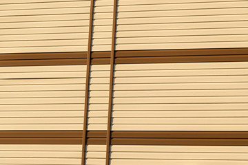 Geometric color elements of the building facade with planes, lines, corners with highlights and reflections for the abstract background and texture of brown, orange, white, colors. Place for text