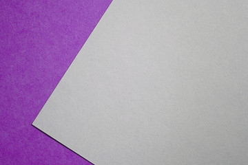 Paper background with paper texture purple color at an angle on a white sheet of paper . Overlaid sheets of paper.