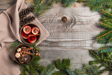 Fruit tea with cinnamon and lemon and decorations on a wooden background