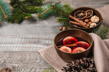 Fruit tea with cinnamon and lemon and decorations on a wooden background