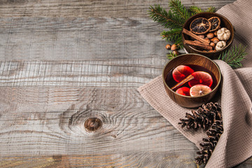 Fruit tea with cinnamon and lemon and decorations on a wooden background