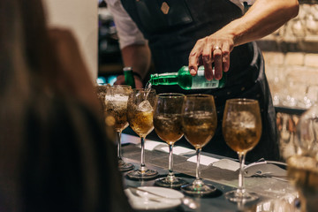 Bartender making cocktails at the bar, alcoholic drinks  