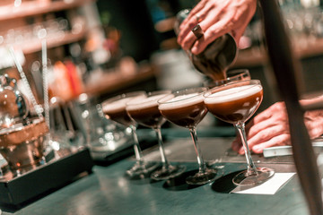 Bartender making cocktails at the bar, alcoholic drinks  