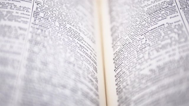4K - Camera moves above the dictionary. Close-up