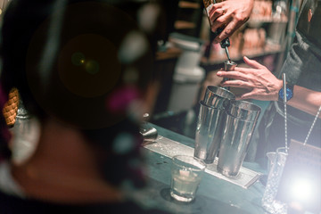 Bartender making cocktails at the bar, alcoholic drinks  