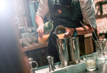 Bartender making cocktails at the bar, alcoholic drinks  