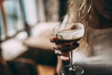 Women holding alcoholic cocktail, summer cocktail in bar