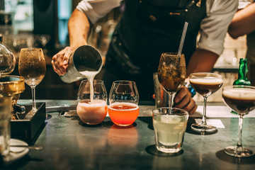 Bartender making cocktails at the bar, alcoholic drinks  