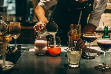 Bartender making cocktails at the bar, alcoholic drinks  