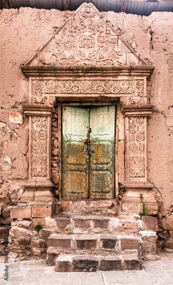 Canvas Prints entrance door of a clay house with decoration in relief on a street of juli city, puno region, peru