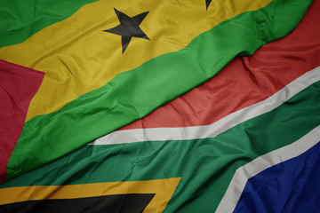 waving colorful flag of south africa and national flag of sao tome and principe .