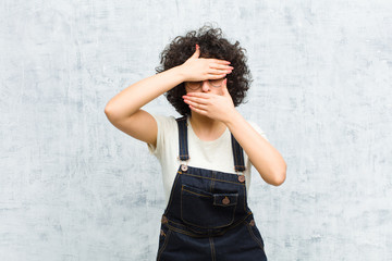 young pretty afro woman covering face with both hands saying no to the camera! refusing pictures or...