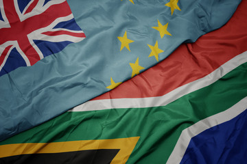 waving colorful flag of south africa and national flag of Tuvalu .