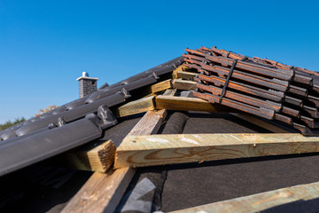 Roof ceramic tile arranged in packets on the roof on roof battens. Preparation for laying roof tiles.