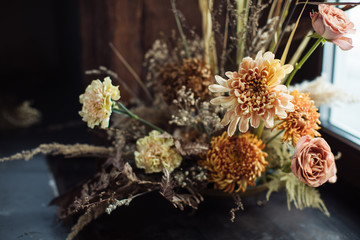Beautiful autumn bouquet of mixed flowers with dry branches. The work of the florist. Beautiful bouquet. Flower delivery