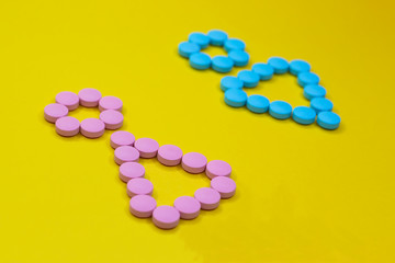 Medicine for men and women. Hormone therapy and oral contraception. Gender symbols from pills.