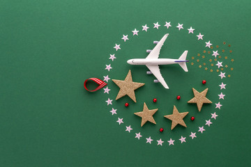 Christmas composition. Christmas ball stars airplane top view background with copy space for your text. Flat lay.