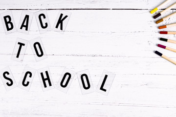 Back to Schoolflat lay of a desk with coloured pencils on the edge. Top down image