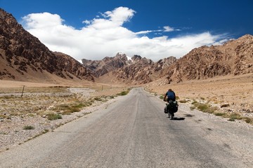 Pamir highway or Pamirskij trakt with biker