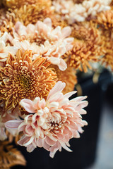 Beautiful autumn bouquet of mixed flowers with peonies. The work of the florist. Flower delivery